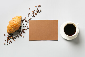 Obraz na płótnie Canvas Composition with blank card, cup of coffee, croissant and coffee beans on grey background