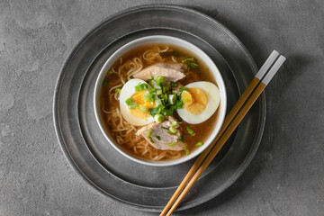Tasty Chinese soup with chicken in bowl on dark background