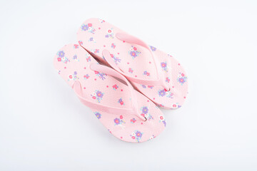 A pair of pink flower flip-flops on white background