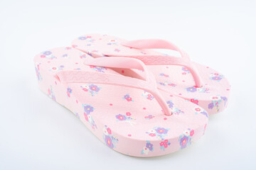 A pair of pink flower flip-flops on white background