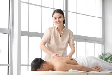 Fototapeta na wymiar Massage therapist working with patient in medical center