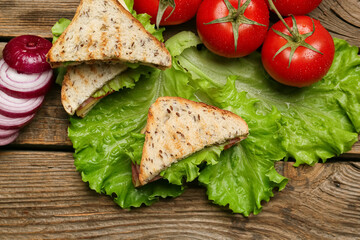 Fototapeta na wymiar Tasty sandwiches on wooden background