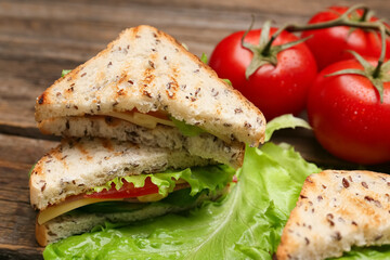 Tasty sandwiches on wooden background, closeup