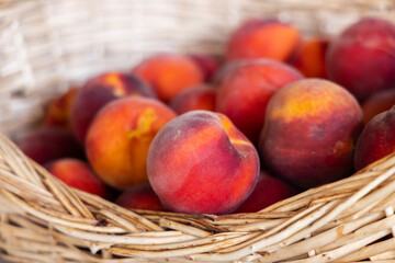 red peaches in a wicker basket