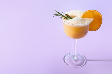 Glass of tasty whiskey sour cocktail on color background