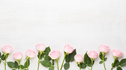 Fototapeta premium Flowers valentine day composition. Frame made of pink rose on gray background. Flat lay, top view, copy space.
