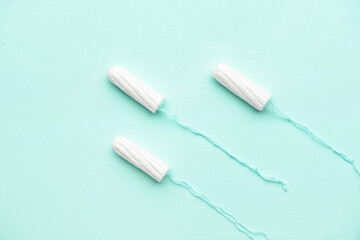 Tampons on color background, top view