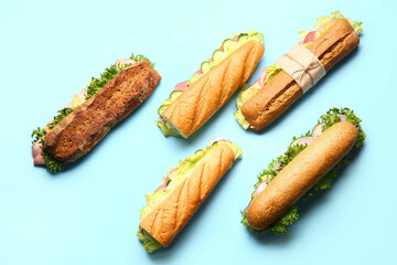 Tasty sandwiches on color background