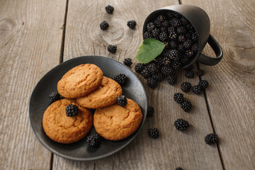 cookies and blackberries on a wooden background