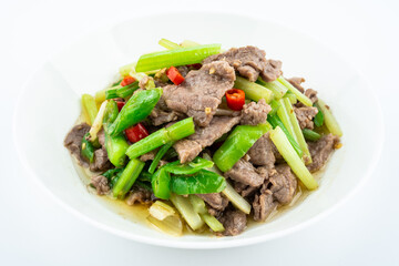 Stir-fried beef with celery on a dish on white background