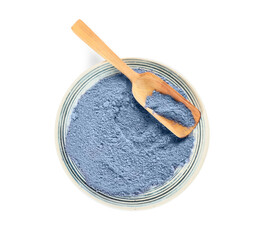 Plate of powdered blue matcha tea and spoon on white background