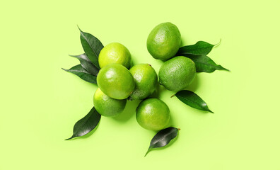 Tasty limes on color background