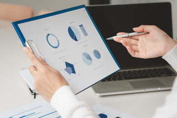 Businessman is deeply reviewing a financial report for a return on investment or investment risk...