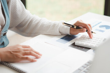 Fototapeta premium Businessman is deeply reviewing a financial report for a return on investment or investment risk analysis.