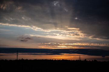 God rays on the forest. The sun's rays shine through the clouds. The power of the sky and a riot of...