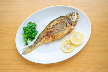 A fried yellow croaker on the table