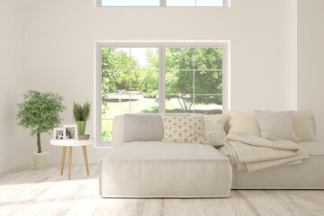 White living room with sofa and summer landscape in window. Scandinavian interior design. 3D illustration