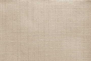 Jute hessian sackcloth canvas woven texture pattern background in light beige cream brown color...