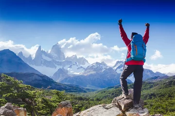 Papier Peint photo Fitz Roy hiker celebrating success on top of a mountain in a majestic Patagonia mountain landscape. Fitz Roy, Argentina. Mountaineering sport lifestyle concept