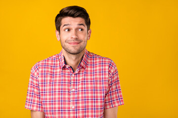 Photo of young handsome man happy positive smile curious look empty space isolated over yellow color background