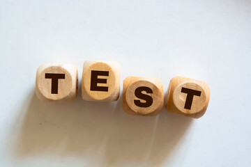 Inscription test on wooden cubes on white background.