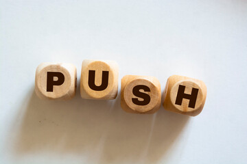 Fototapeta na wymiar Time to push. Wooden cubes form the word 'push' on white background. Business and push concept. Copy space.