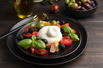 Buffalo mozzarella or burrata cheese with tomatoes and olivesl italian food, caprese salad