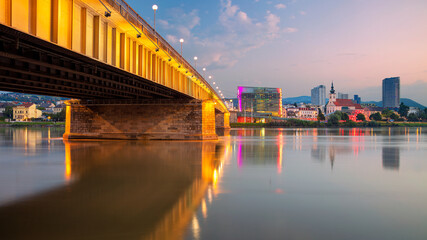 Linz, Austria. Cityscape image of riverside Linz, Austria at summer sunrise with reflection of the...