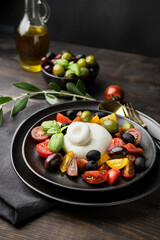 Buffalo mozzarella or burrata cheese with tomatoes and olivesl italian food, caprese salad