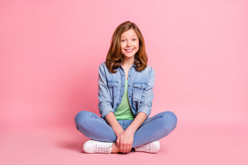 Obraz na płótnie Canvas Full length photo of young cheerful girl happy positive smile sit floor lotus pose isolated over pink color background