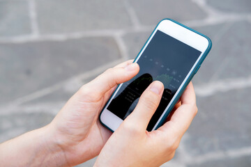 Stock market investor hands holding a phone investment app index growth chart, private banking, private investment