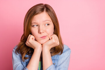 Photo of young girl hands touch chin think thoughtful dream look empty space isolated over pink...