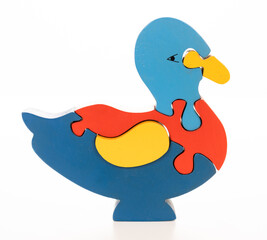 Wooden duck puzzle on white background