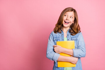 Photo portrait girl smiling keeping copybook looking copyspace isolated pastel pink color background