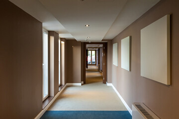 Interior of a long corridor with mock up for paintings, blank frame