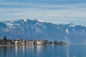 Small village by Geneva Lake with Swiss alps on the back