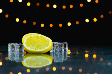 close up slice fresh lemon and ice on table in front of light background