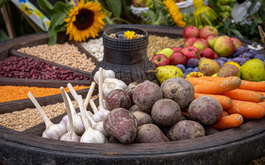 Colorful selection of fruits and vegetables in an old wooden carriage wheel. 
Beetroots, carrots,...