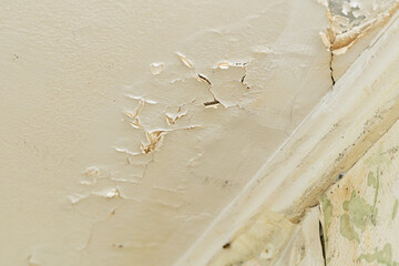 Broken plaster on the ceiling after a water leak from the upper floor