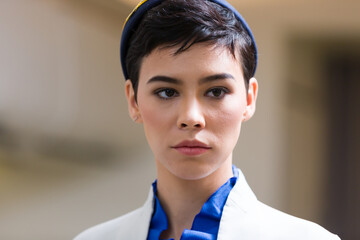 Closeup of flight attendant. Air hostess in dress suit. Stewardess in airplane. Lifestyle, travel...