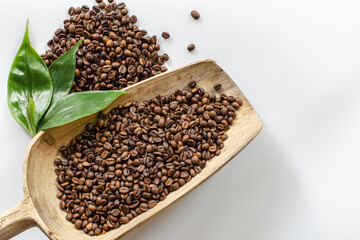 coffee beans lie in a wooden large spoon