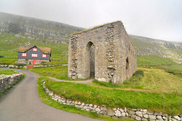 Fototapeta na wymiar St. Magnus Cathedral - a ruined cathedral in the village of Kirkjubøur on the island of Streymoy in the Faroe Islands