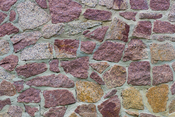 The texture of the masonry of uneven stones.