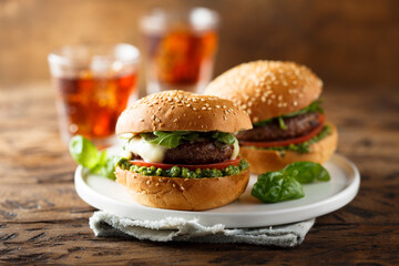 Traditional homemade beef burgers with pesto sauce