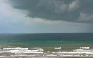 Dramatic view of the sea during an onset of a storm, ocean with dramatic colors of blue and gray