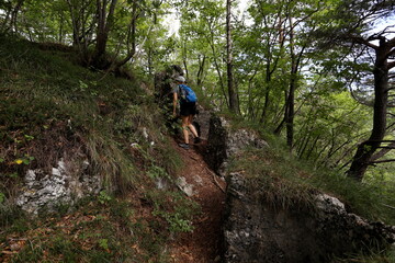 A girl explores the 18th century forts on the Mezzolago tumulus, on the shores of Lake Molveno. Trentino, Italy.