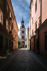 CITYSCAPE - An atmospheric street in Poznan with historic tenement houses and a church 

