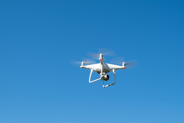 Drone or quadrocopter while flying in the sky.