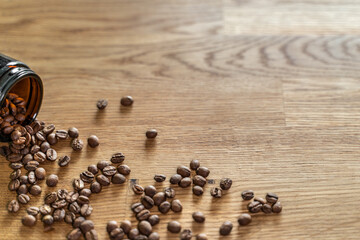 Coffee beans on the wooden table with a background.