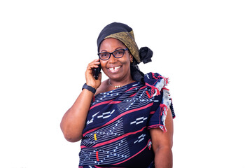 close-up of a beautiful African woman in traditional dress with cellphone, happy.